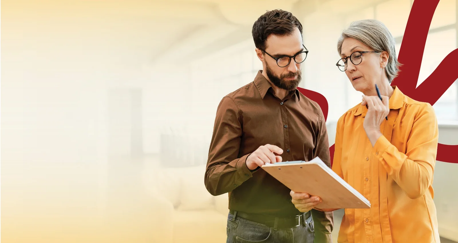 Man and woman looking at papers on a clipboard